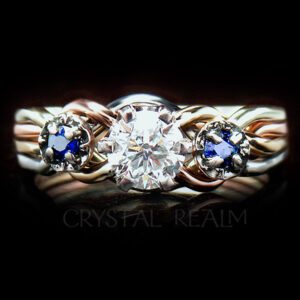 Four color 4 piece puzzle ring with half carat round diamond and side sapphires