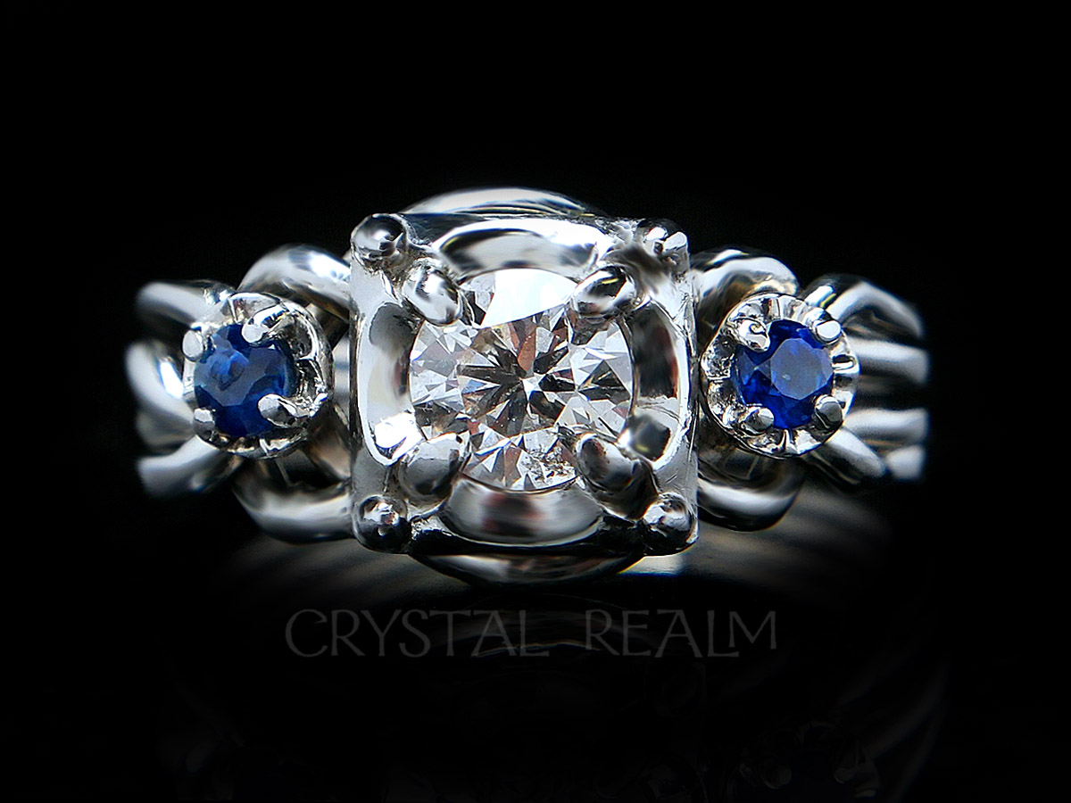 4 piece puzzle ring with round center diamond and two round side sapphires