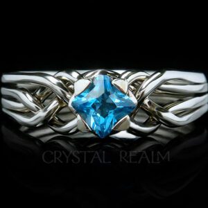 Four-piece puzzle ring with princess cut blue topaz in a medium-low setting