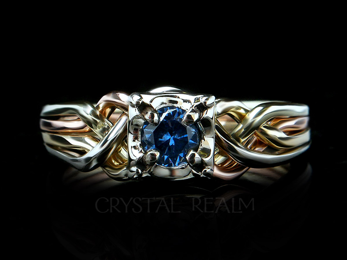 4 band puzzle ring with round lab created blue zircon and bands of four colors 14k gold