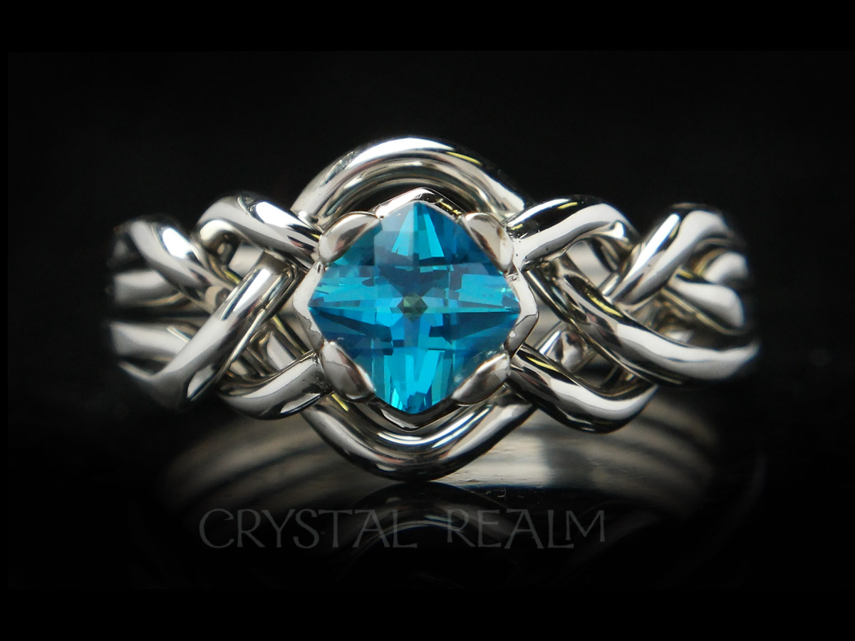 four piece puzzle ring with blue topaz and open weave