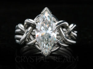 Four band, medium-heavy weight puzzle ring bearing a 1.85CT marquise moissanite