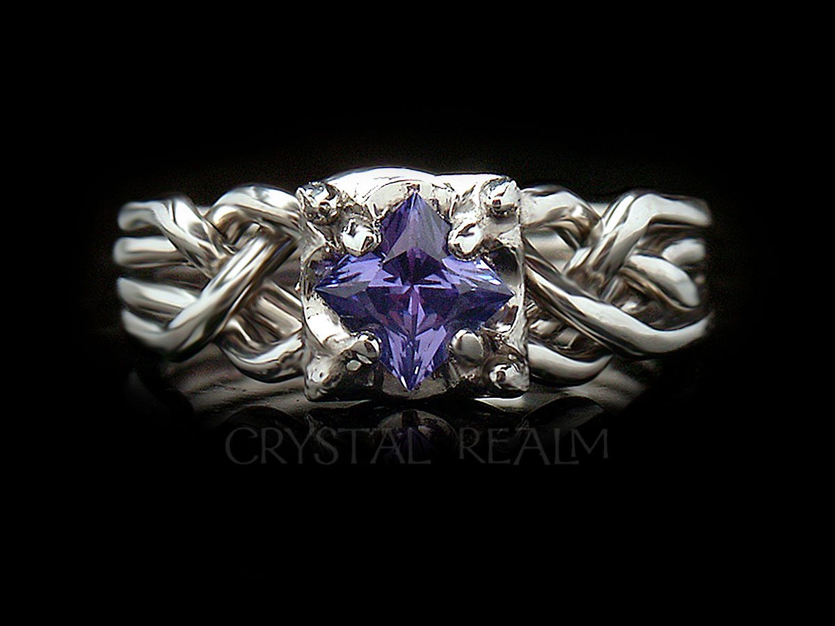 Guinevere four piece puzzle ring with princess cut tanzanite