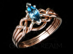 A genuine, marquise blue topaz engagement puzzle ring in 14K rose gold