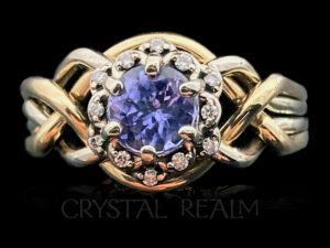 tanzanite engagement puzzle ring with twelve diamond halo