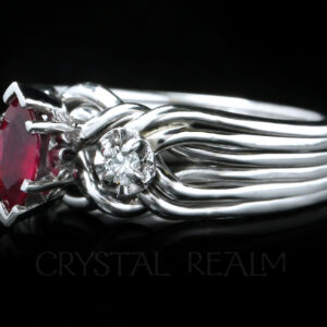 three-quarter view of our six band platinum engagement puzzle ring with marquise ruby center and side diamonds