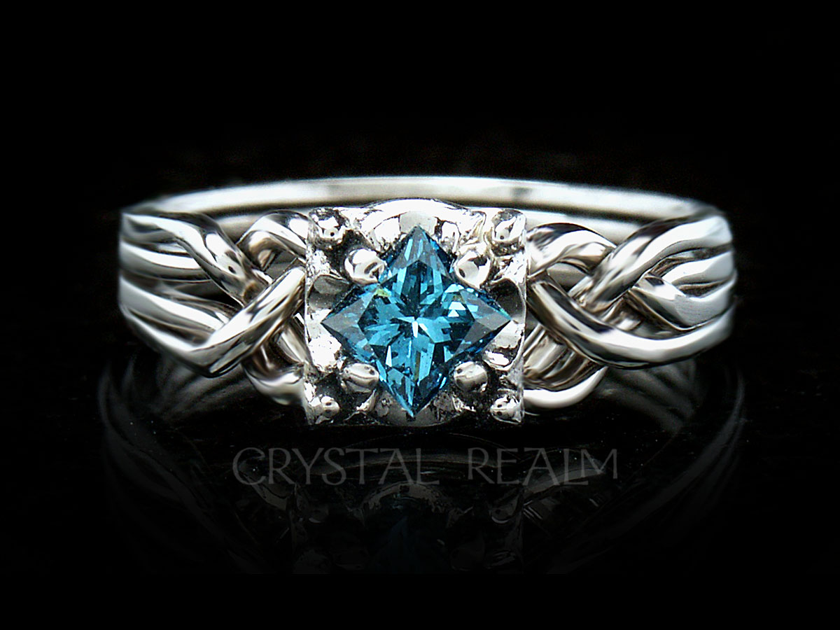 Princess cut blue diamond on Guinevere four band puzzle ring